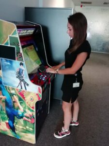 TNation employee playing an arcade game